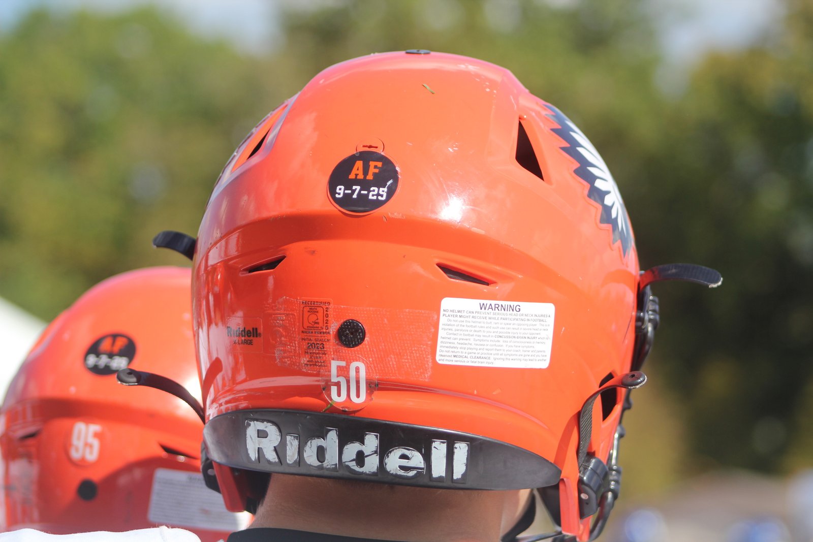 The Brother Rice helmets sport a memorial sticker in honor of legendary coach Al Fracassa, who passed away at 92 years of age this September. Fracassa led the Warriors to nine state championships.