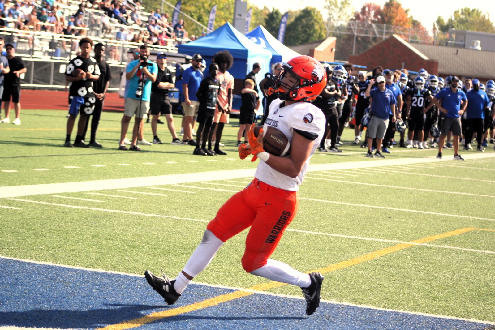 Caden Hong rushes for a touchdown against Catholic Central. Since that game on Oct. 5, the Warriors have won out, improving their record to 5-4.