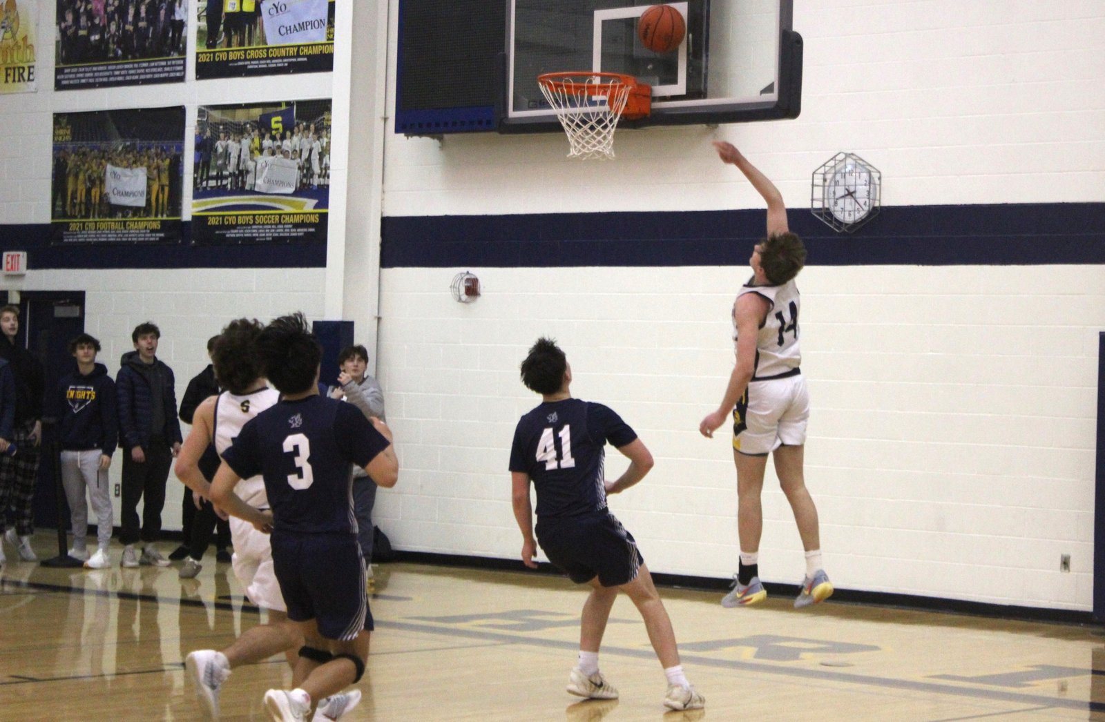 Owen Wisniewski finishes off a Shrine fast break by making a lay-up. Wisniewski and four of his basketball teammates are traveling to New York City for a choir trip during the opening weekend of the Catholic League playoffs.