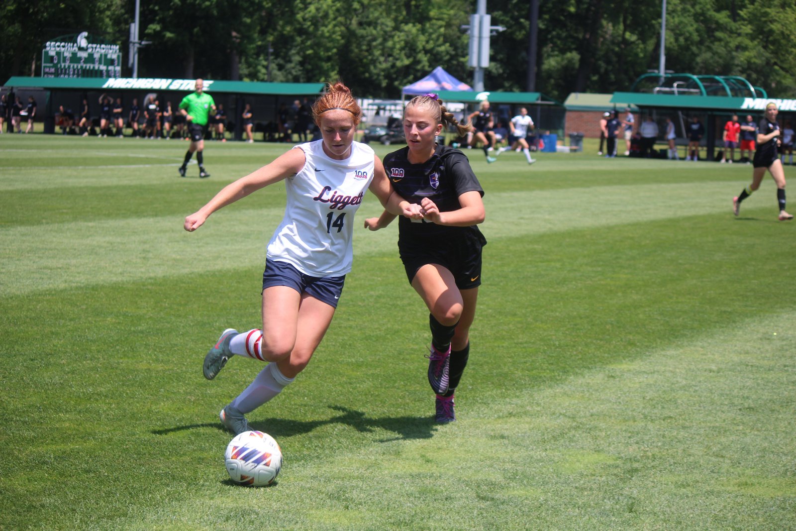 University-Liggett senior Kerith Short tries to break free while being marked by Kalamazoo Christian midfielder Hannah Hoeksema.
