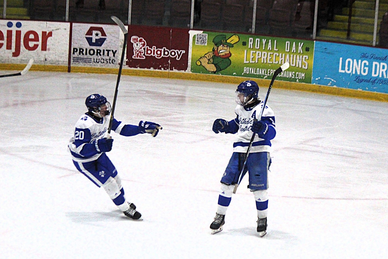Eian Szerlip (right) tied the game at 2 midway through the second period with a shot from the corner of the rink. Dominic Testani (20) rushes in to congratulate Szerlip.