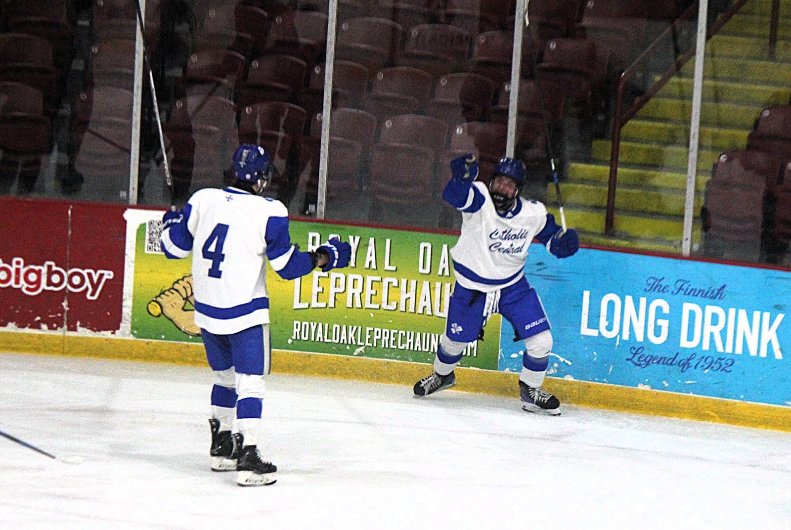 Sean Goff (4) rushes over to celebrate a second-period goal from Lucas Szmagaj (right), which gave Catholic Central its first lead in an eventual 4-3 victory over Toledo St. Francis.