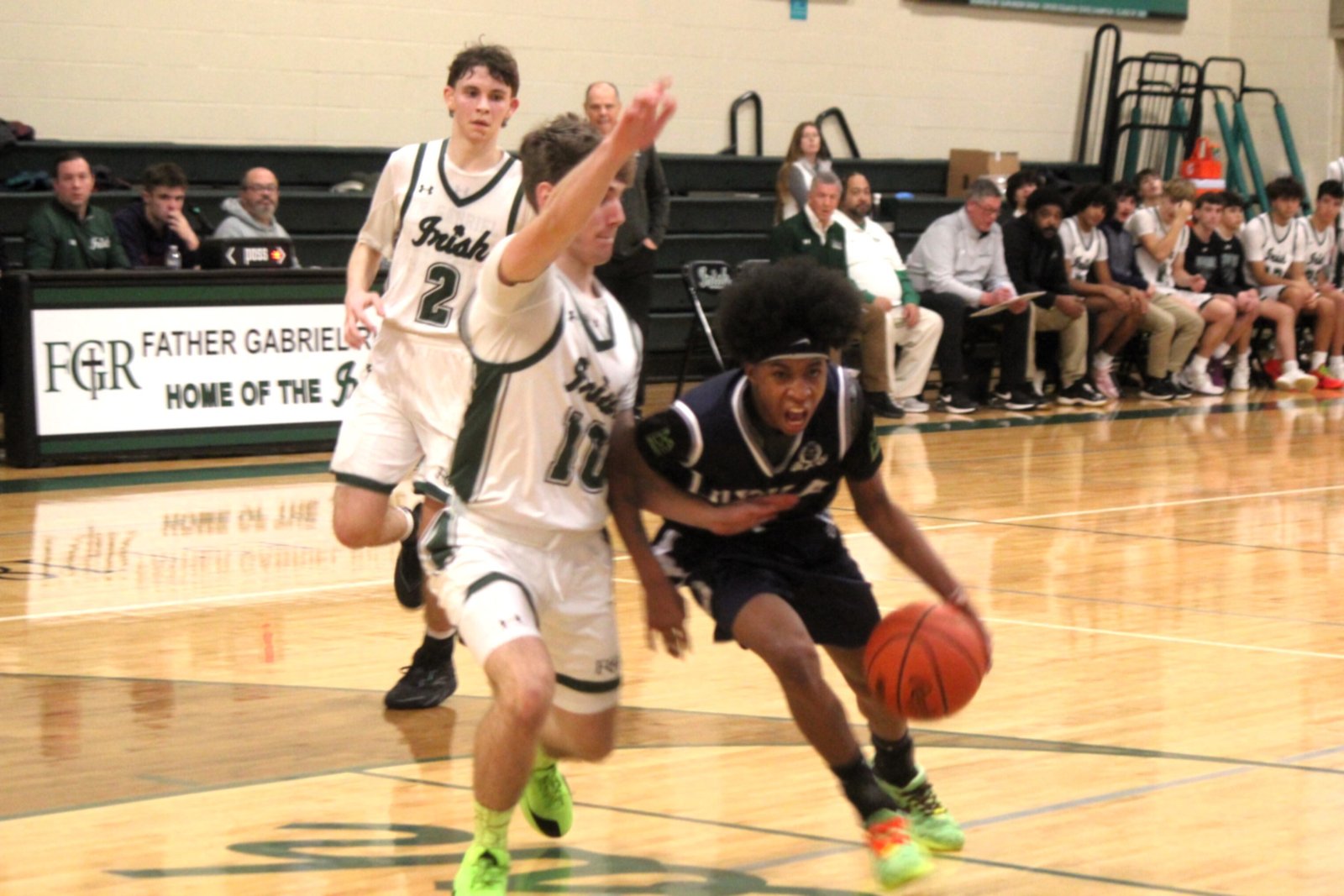 Loyola senior Martez Davis gets by an Ann Arbor Fr. Gabriel Richard defender and drives for the hoop. Davis and Donovan Clark, with 13 points apiece, tied for game-high honors in the Bulldogs’ 63-43 victory over the Fighting Irish on Jan. 6.