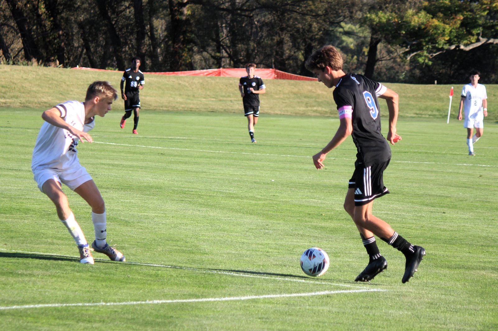 Catholic Central’s Grant Mooradian aims to beat Cranbrook defender Will Garibaldi in the Catholic League championship contest. Mooradian had a second-half goal to help power the Shamrocks to a 4-0 win.