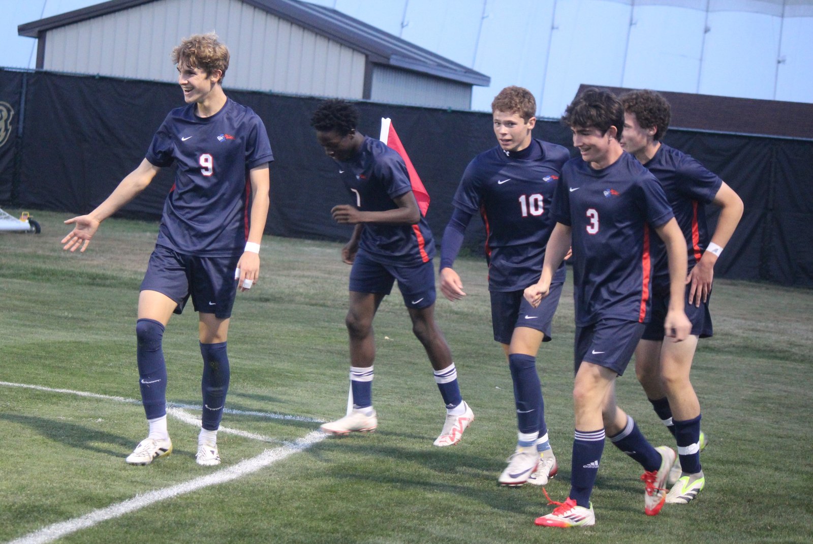 University-Liggett players celebrate after Brady Ancona (10) scored the first goal of the game. The Knights went on to post a 4-2 victory over Royal Oak Shrine to win the Cardinal Division title.