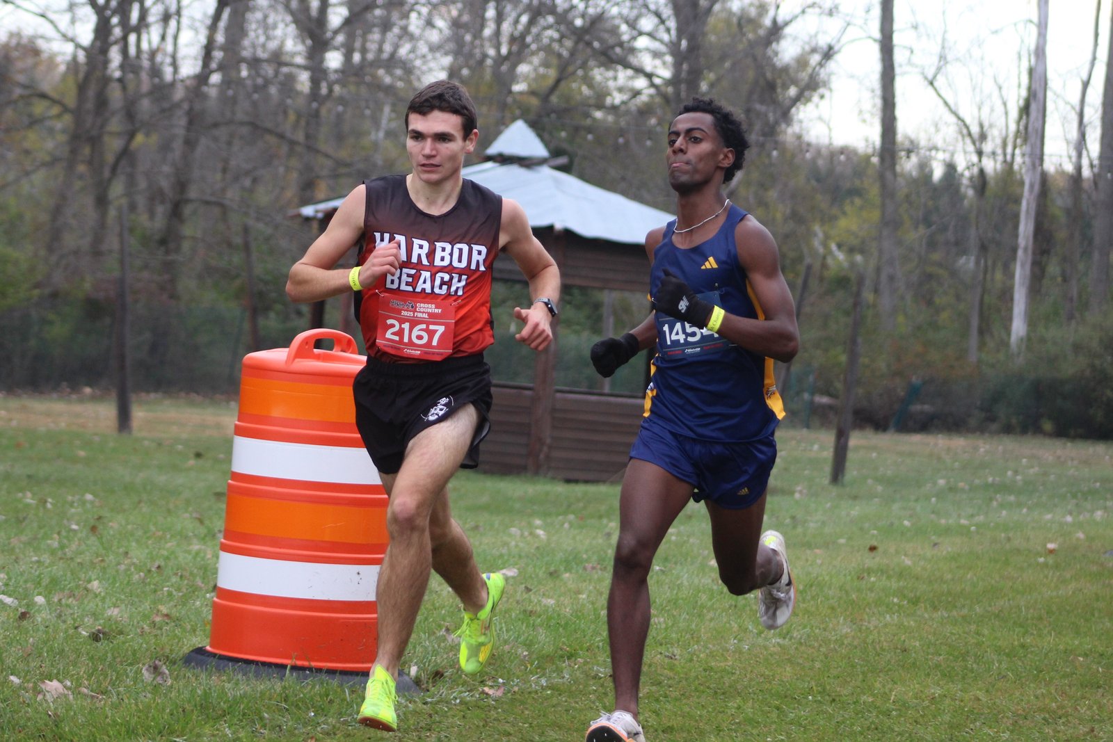 Royal Oak Shrine senior Abenezer Cerone (right) jockeys for position midway through the race with Brody Karg of Harbor Beach. Karg eventually finished second with Cerone placing third.