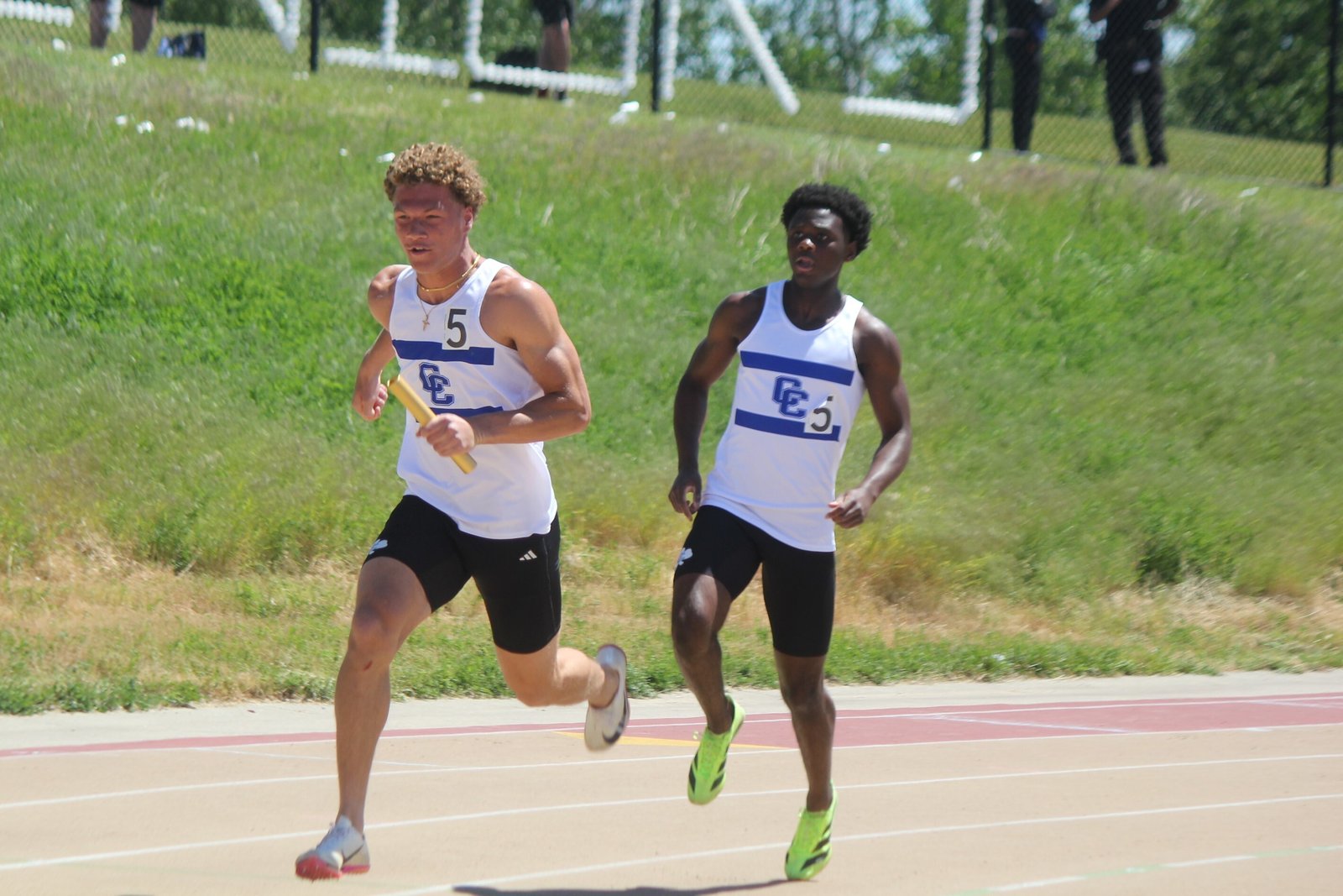 Catholic Central’s Gideon Gash takes the baton from teammate Dylan Gamnje at the first exchange of the 4x200 relay. The Shamrocks won the race — and the state championship — in 41.50 seconds.