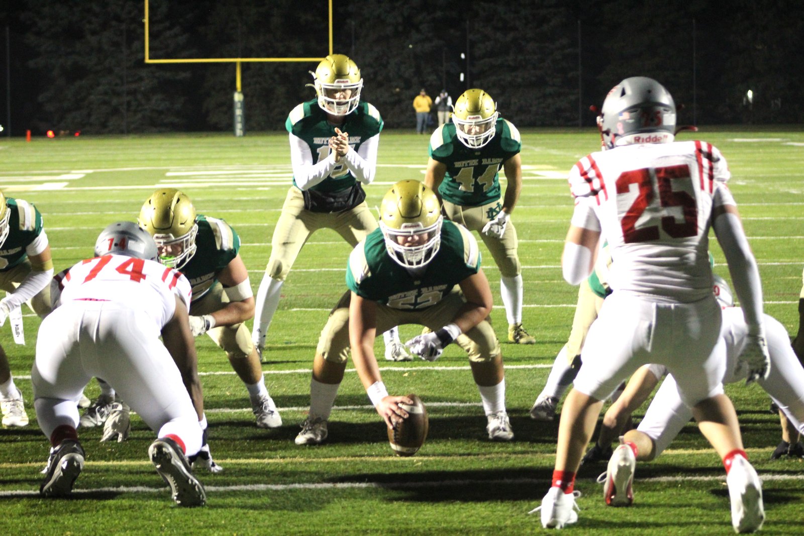 Logan Tuttle (52) prepares to snap the ball to quarterback Sam Stowe (15), with Anthony Tartaglia (44) to the left of Stowe. Tartaglia scored on this play, a 1-yard burst, for Notre Dame Prep’s first touchdown of the night.