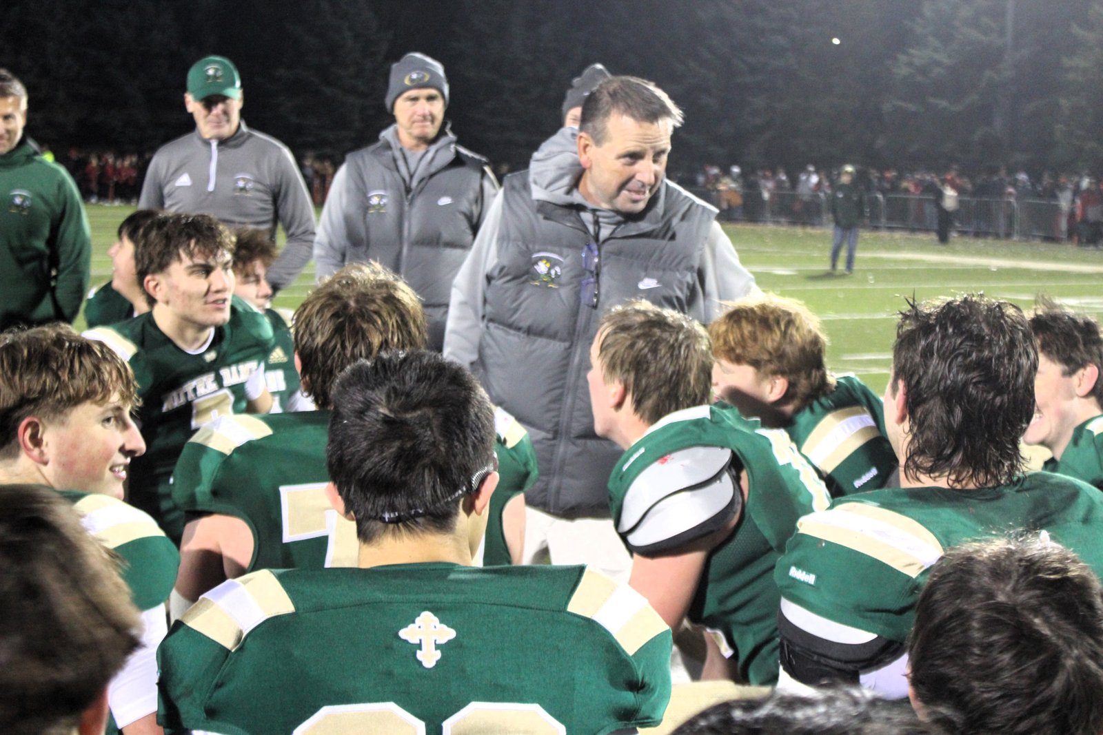 Head coach Pat Fox has a few words with his team in the post-game huddle following Notre Dame Prep’s home-field win over Frankenmuth, earning the Fighting Irish the regional championship.
