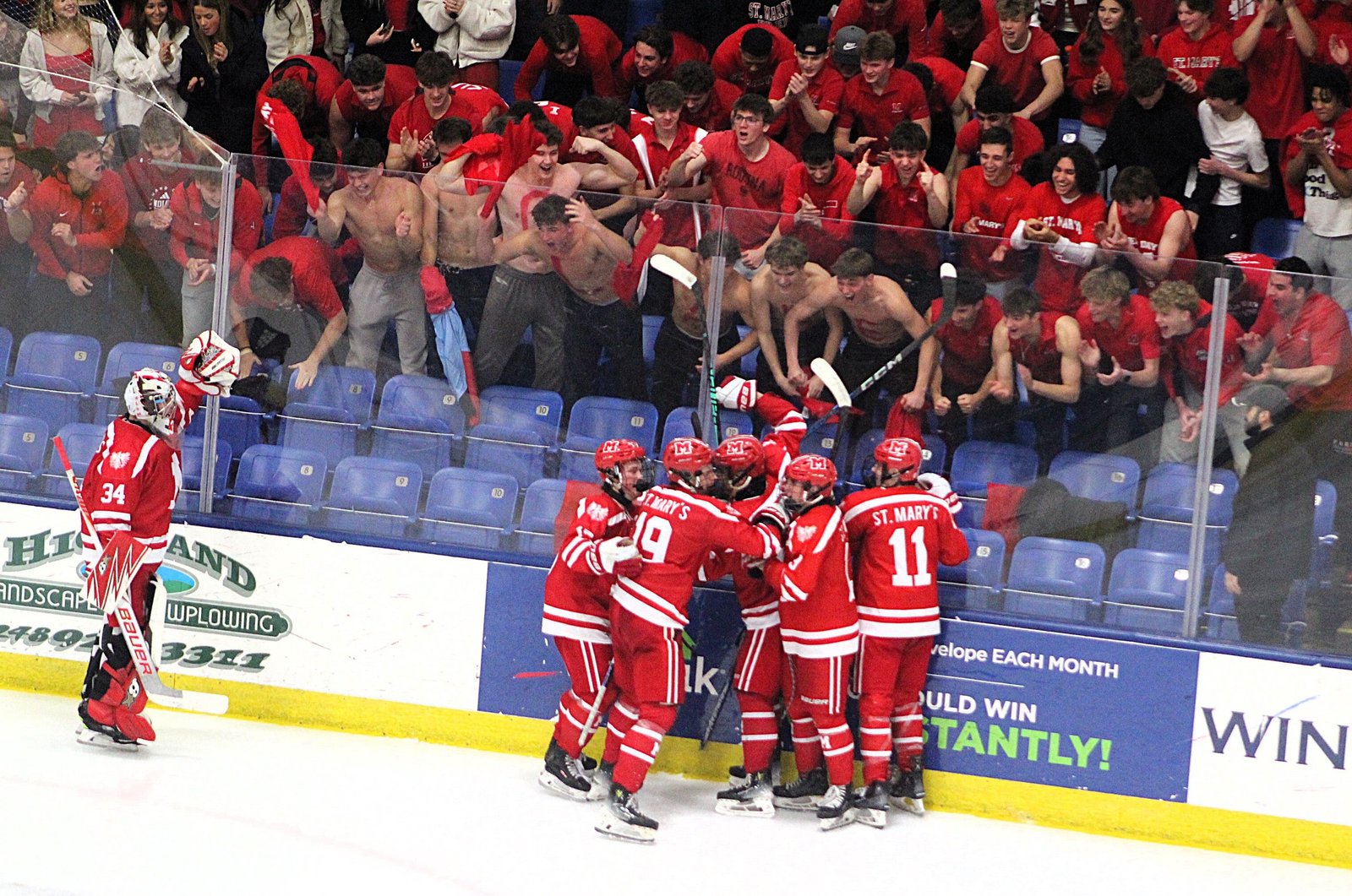 Orchard Lake St. Mary’s skaters and fans celebrate the third-period go-ahead goal by Dominic Pizzo (19) during Saturday’s MHSAA Division 3 state championship game. Although Pizzo’s tally put the Eaglets up 2-1, the joy was short-lived as Houghton tied the score less than a minute later.