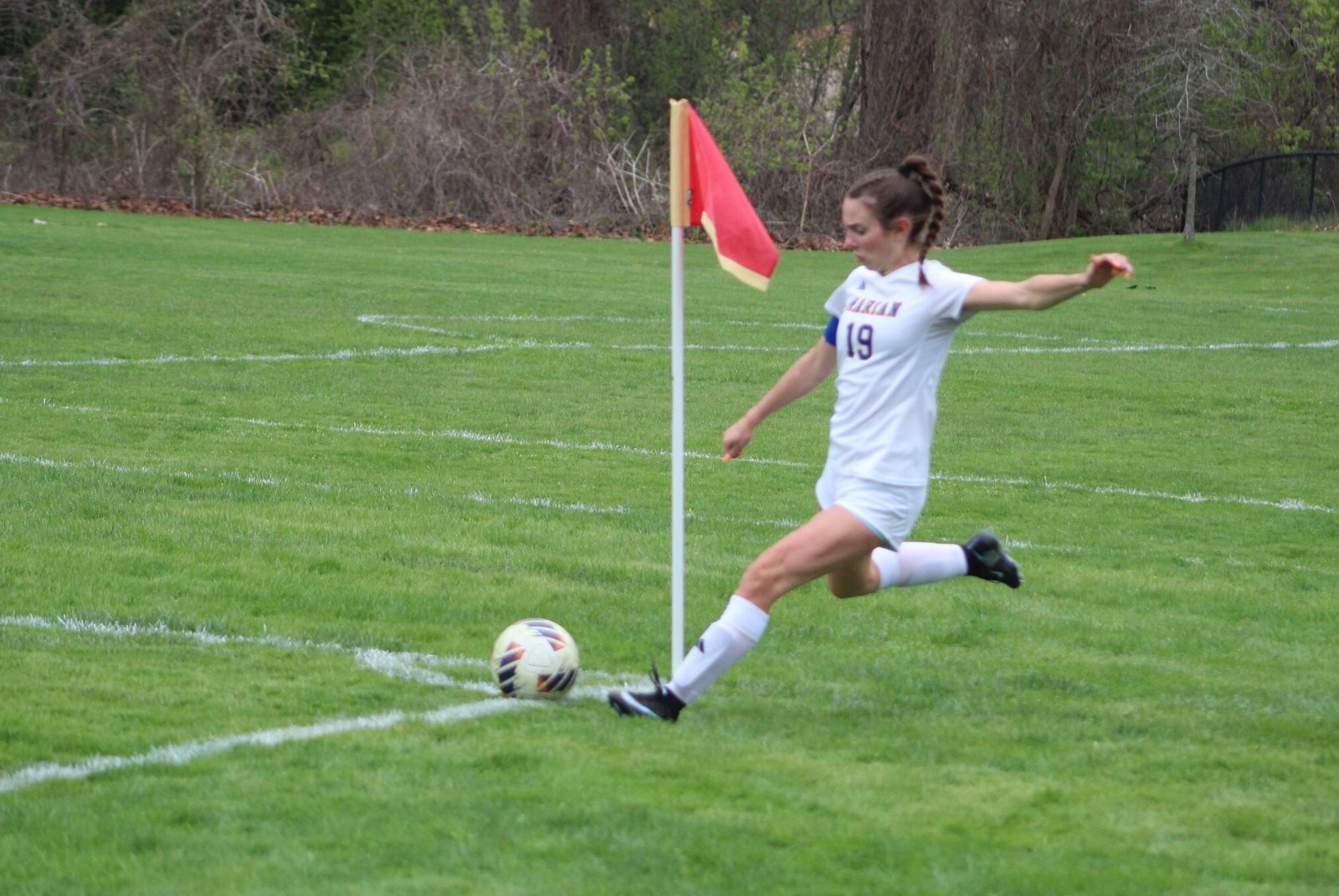 Lily Robinson, a four-year member of the Marian varsity and one of four team captains, puts the ball in play via a corner kick.