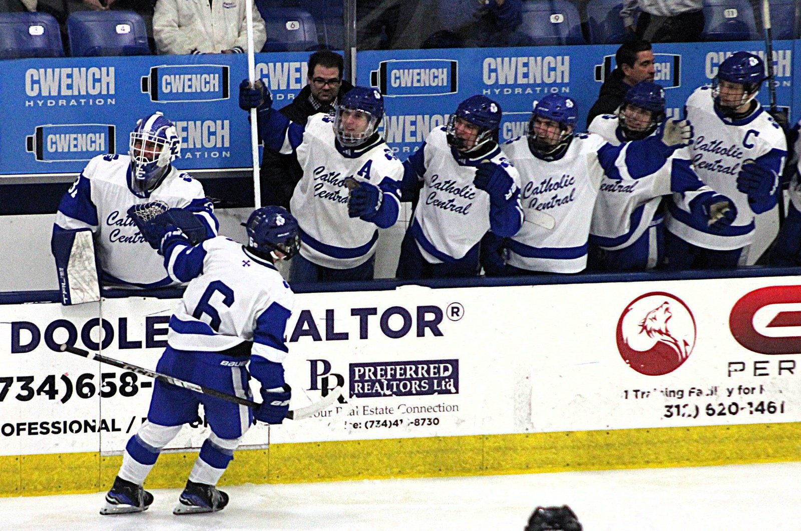 Catholic Central teammates congratulate Lucas Szmagaj on his third-period goal, which put the Shamrocks up midway through the third period, 5-0.