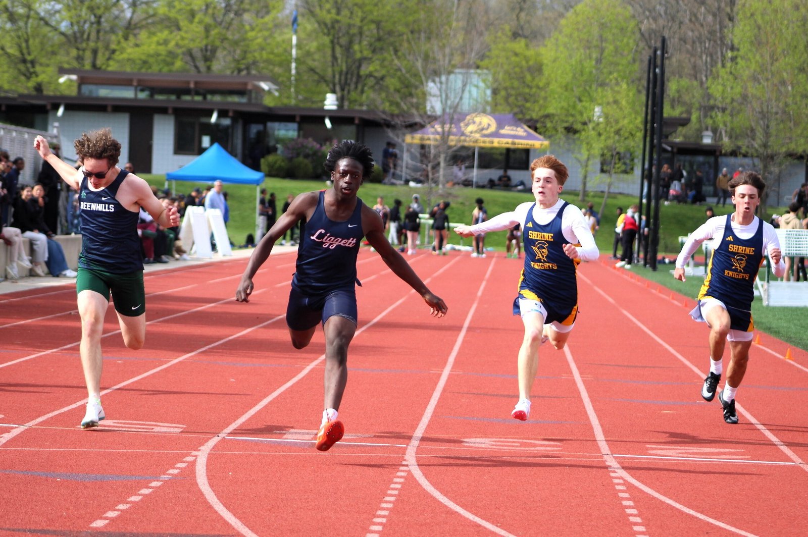 Ann Arbor Greenhills’ Rowan Bryer, Grosse Pte. Woods University-Liggett’s Sekou Manneh, Royal Oak Shrine’s Josh Zboril and Shrine’s Jack Rice lunge to the finish line in the 100-meter dash. Manneh won the race – and the Catholic League title ─ in 11.23 seconds.
