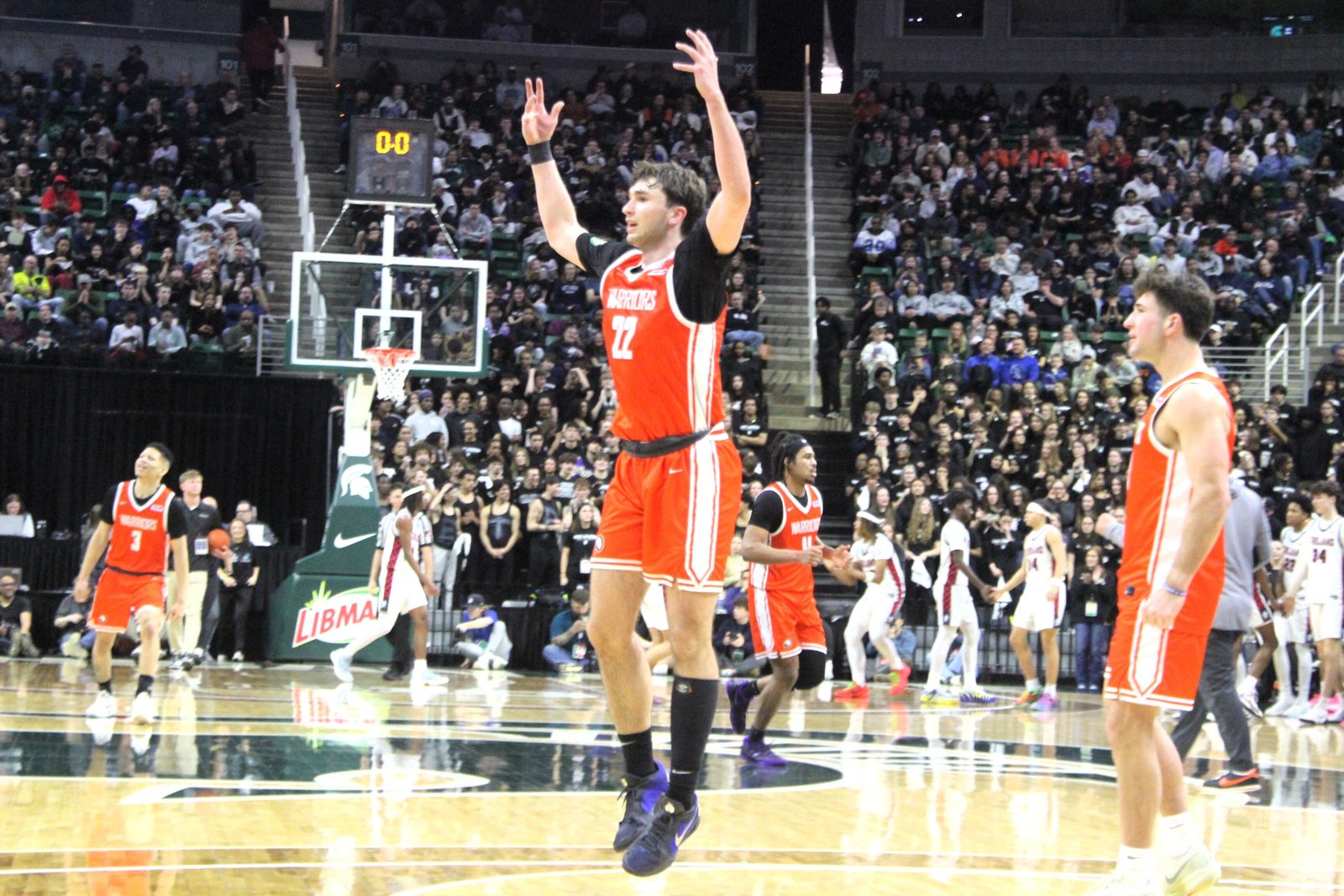 Trevor Smith pumps up the Brother Rice crowd after the Warriors wiped out an 8-point deficit to take a 37-36 lead at the completion of the third quarter.