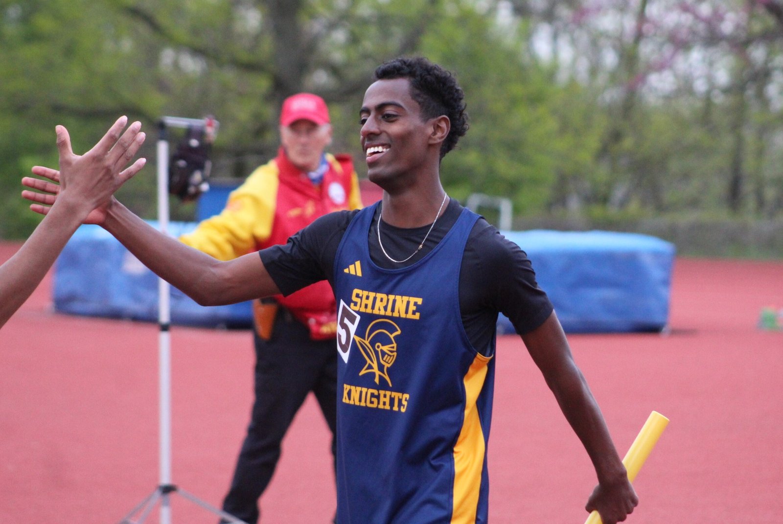 Royal Oak Shrine senior Abenezer Cerone is congratulated by a teammate after anchoring his school’s 4x400 relay team to a victory in the final event of the meet. The Butler commit also won the 1600- and 800-meter runs and played a role in Shrine’s first-place 4x200 relay.