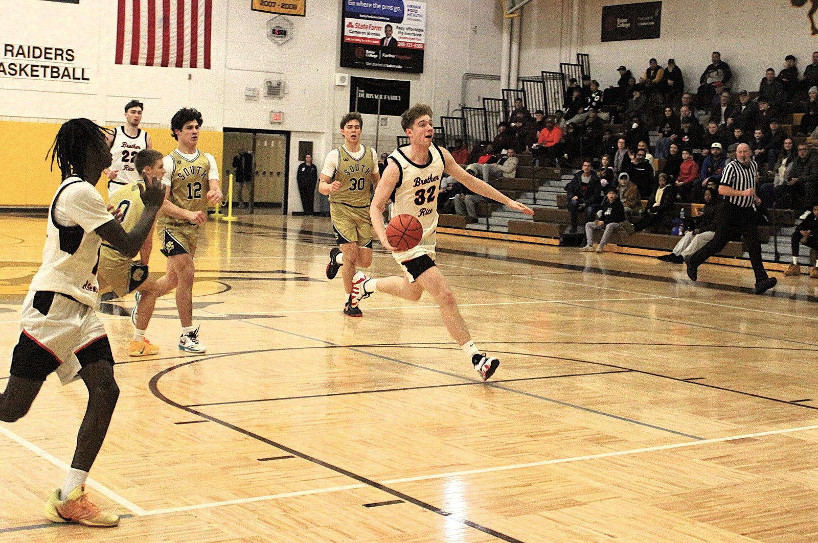 Sophomore Stefan Banica takes the ball upcourt on a fast break. New to the Warriors this year, he contributed 16 points in the team’s 54-44 win over Grosse Pointe South.