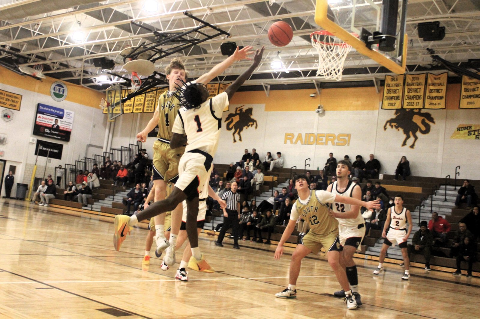 Freshman guard Jordan McDaniel drives for a bucket against Grosse Pointe South during the North Farmington Holiday Extravaganza on Dec. 29. McDaniel, who netted 18 points in the Warriors’ 10-point win, has led the team in scoring in each game.