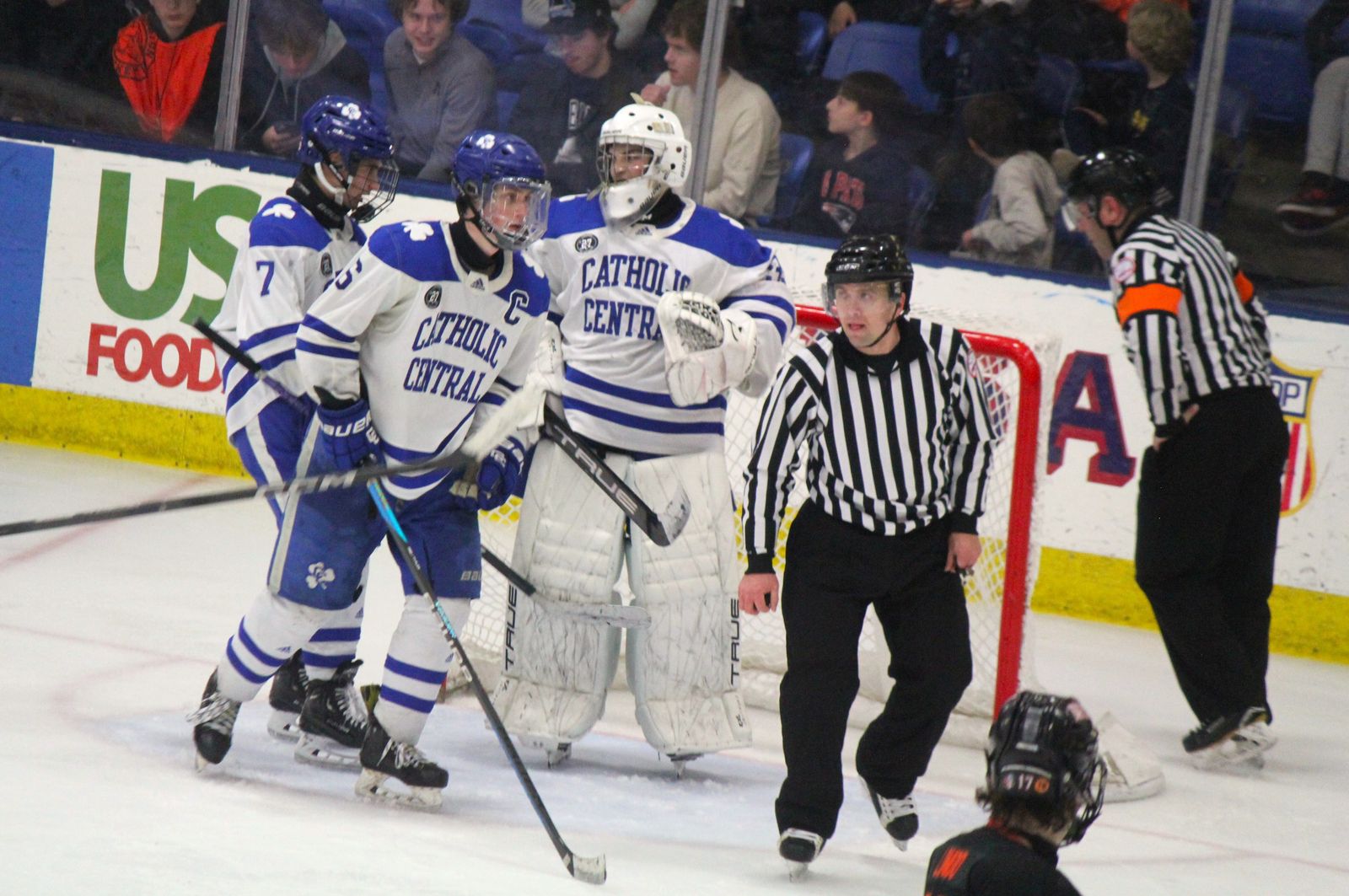 Teammates Peter Sanin (7) and Nolan Galda (16) congratulate Mathieu Chernauckas on a save. The senior goalie turned away all 25 Brighton shots to earn a shutout in the state championship game. (Photo by Wright Wilson | Special to Detroit Catholic)