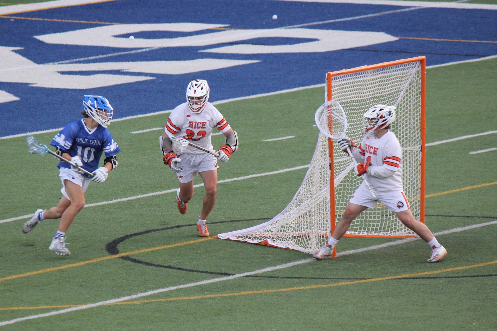 Connor Lukas rushes the Brother Rice goal as Sam Klein defends and Cam Sims stands ready in the crease during fourth-quarter action.