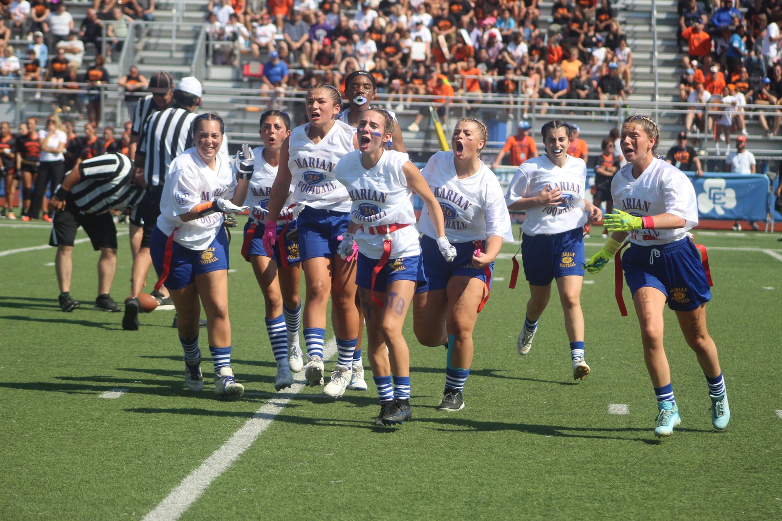 Marian’s defensive unit celebrates after making a crucial fourth-down stop late in the game, which was played at Detroit Catholic Central.