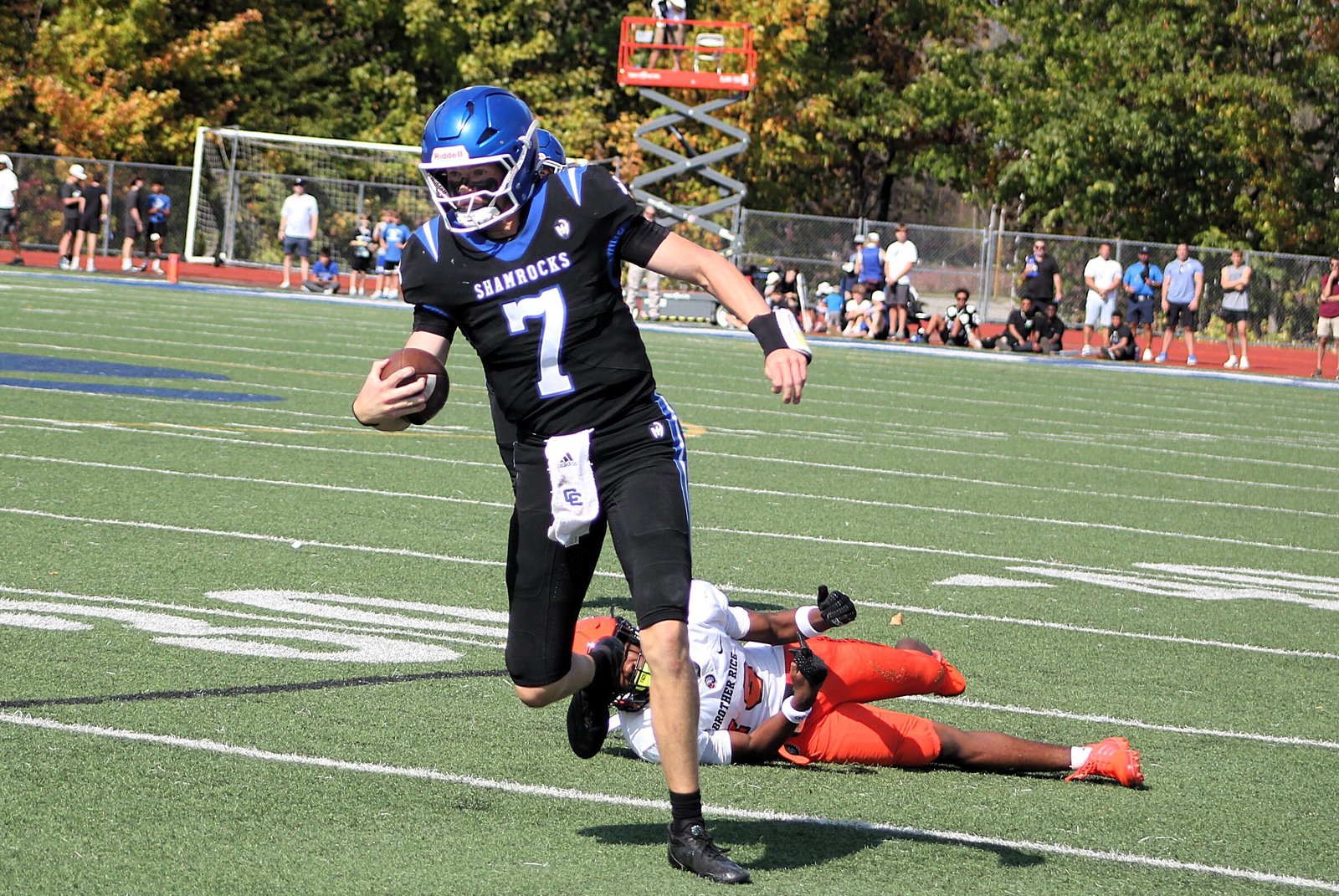 Catholic Central quarterback Duke Banta scrambles for first-down yardage. He threw three touchdown passes in the Shamrocks’ 41-8 Boys Bowl victory.