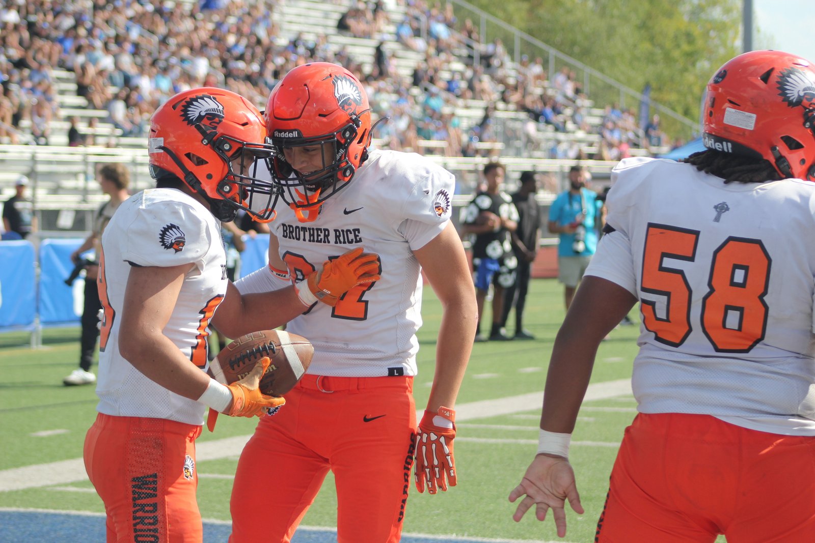 Maximus Giglio congratulates Caden Hong after Hong’s 3-yard run in the fourth quarter put Bloomfield Hills Brother Rice on the scoreboard against Catholic Central.