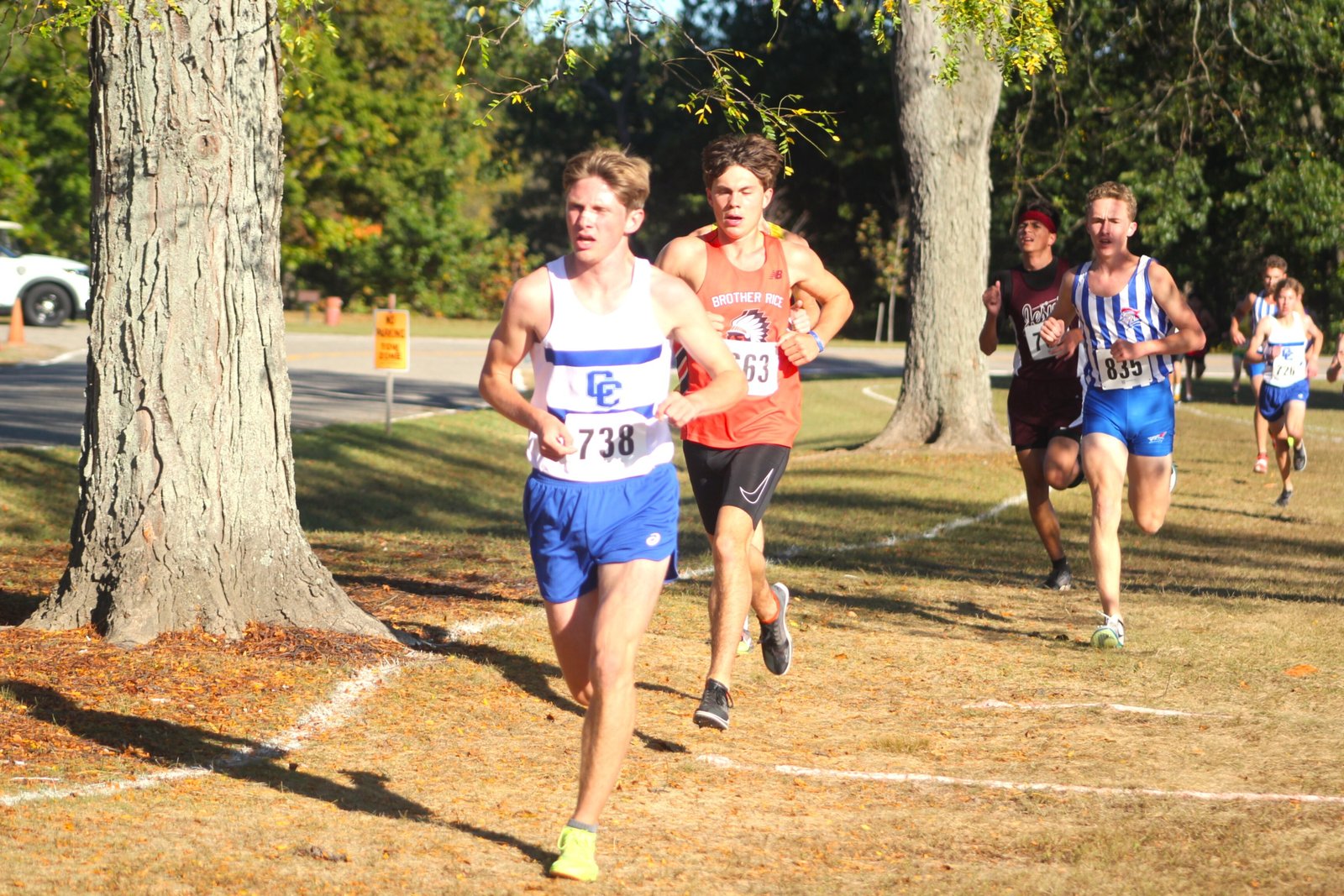 Nolan Collins of Brother Rice tucks in behind Detroit Catholic Central’s Gavin Tisch early in the second mile of the Catholic League Bishop Division cross-country championship race. Collins would eventually overtake Tisch and his teammate, Brady Glon, to win the race.