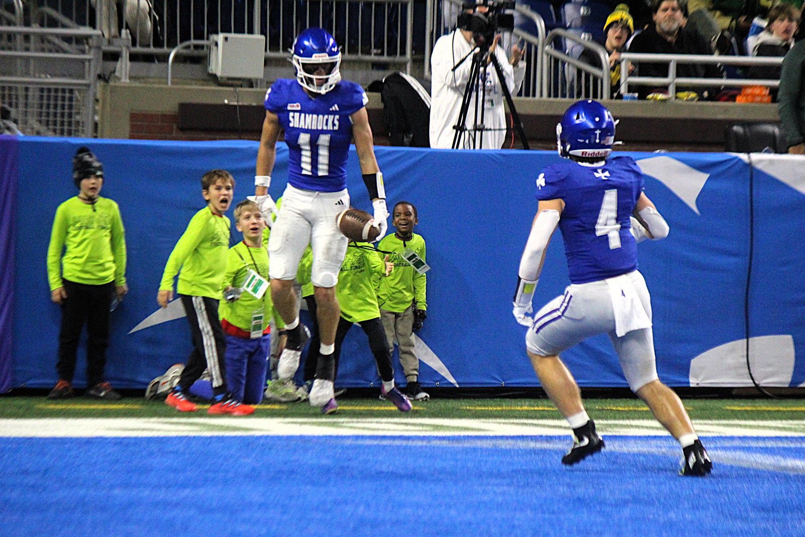 Gideon Gash (11) celebrates with Cameron Swearingen after catching a touchdown pass ─ one of three he had in Detroit Catholic Central’s victory over Detroit Cass Tech.