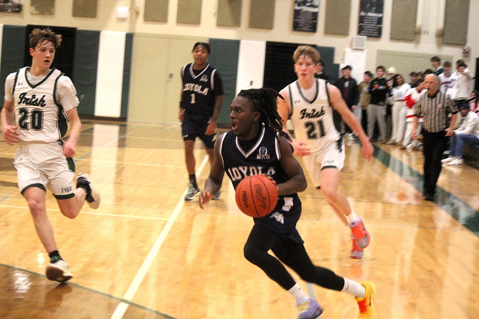 Not only does Cody Champion excel on the bowling lanes, he’s a member of Loyola’s varsity basketball program. Here, he takes the ball toward the hoop during a 20-point win at Ann Arbor Fr. Gabriel Richard in January.